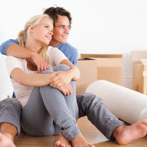 Smiling couple sitting on the floor