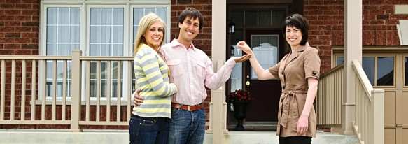 Happy couple with real estate agenta