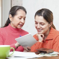 daughter and mother counts the family budget