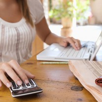 Woman with calculator and laptop